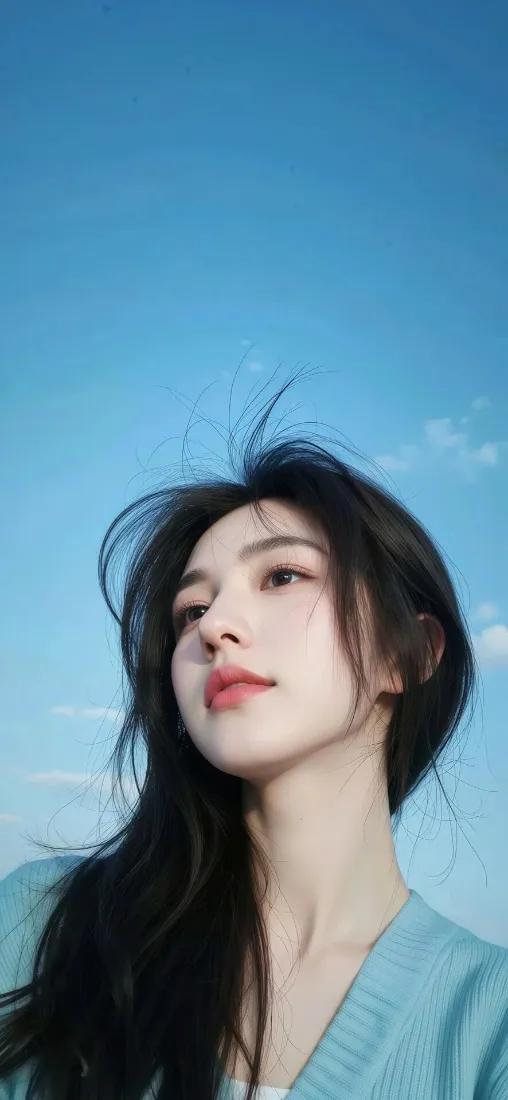 仰拍视角下，长发穿浅蓝色上衣的年轻女性，背景是澄澈蓝天与零星白云。