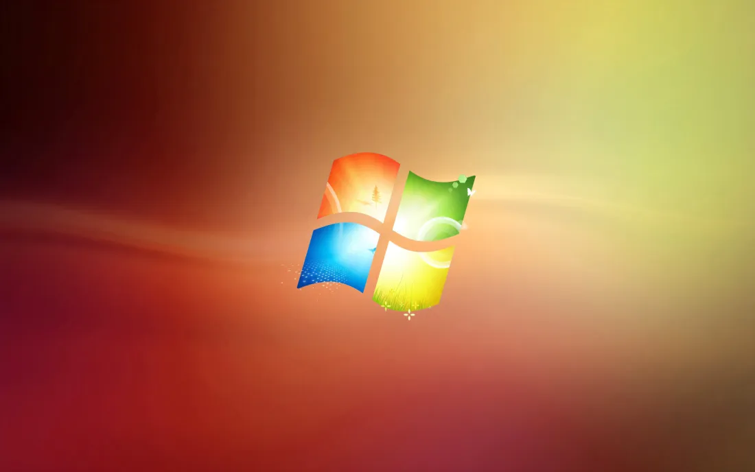 暖橙渐变背景中央悬浮着四色发光的Windows7系统标志
