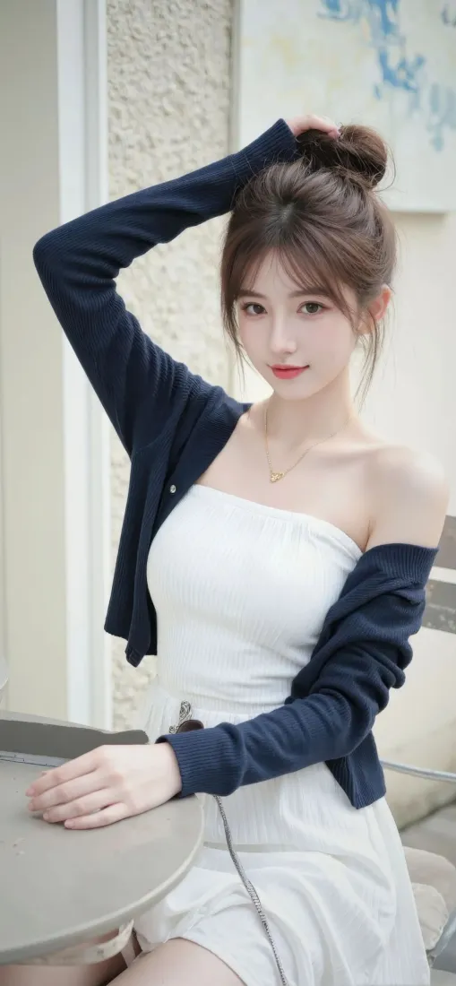 丸子头年轻女子身着白色抹胸裙与藏青色开衫，在室内居家环境中抬手扶头倚靠桌边。